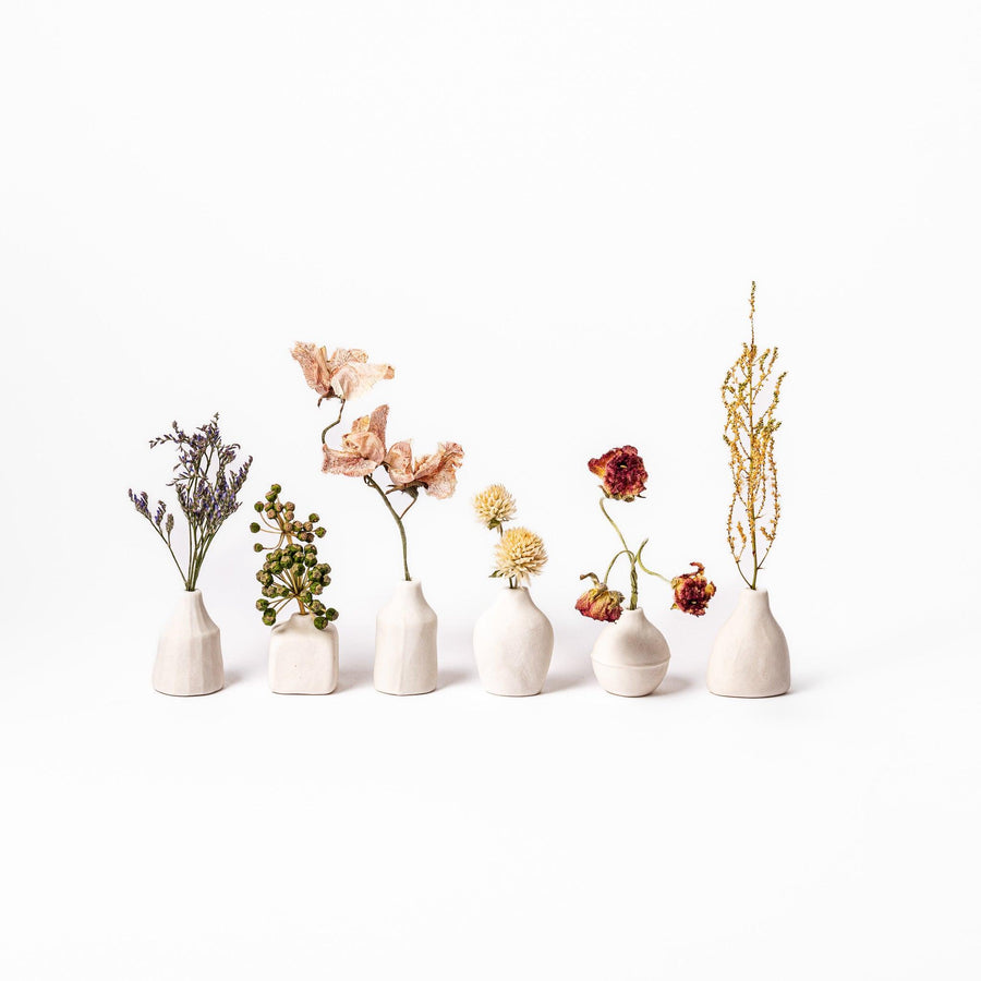 White ceramic bud vase with dried flowers, perfect for adding simple, elegant Japanese-inspired decor to any space.