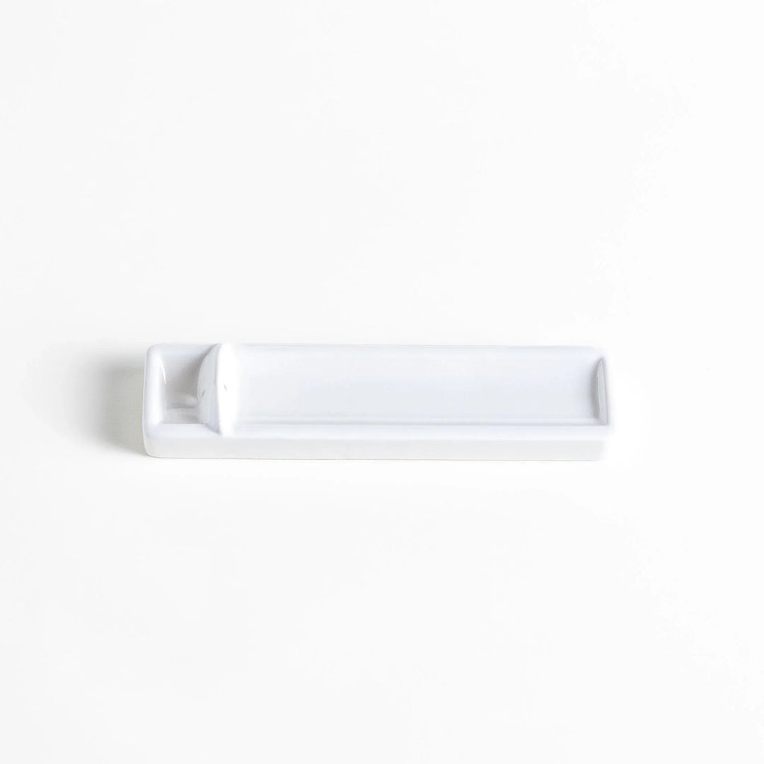 Minimalist white ceramic Japanese incense holder with rectangular shape and slot for clean ash catching.