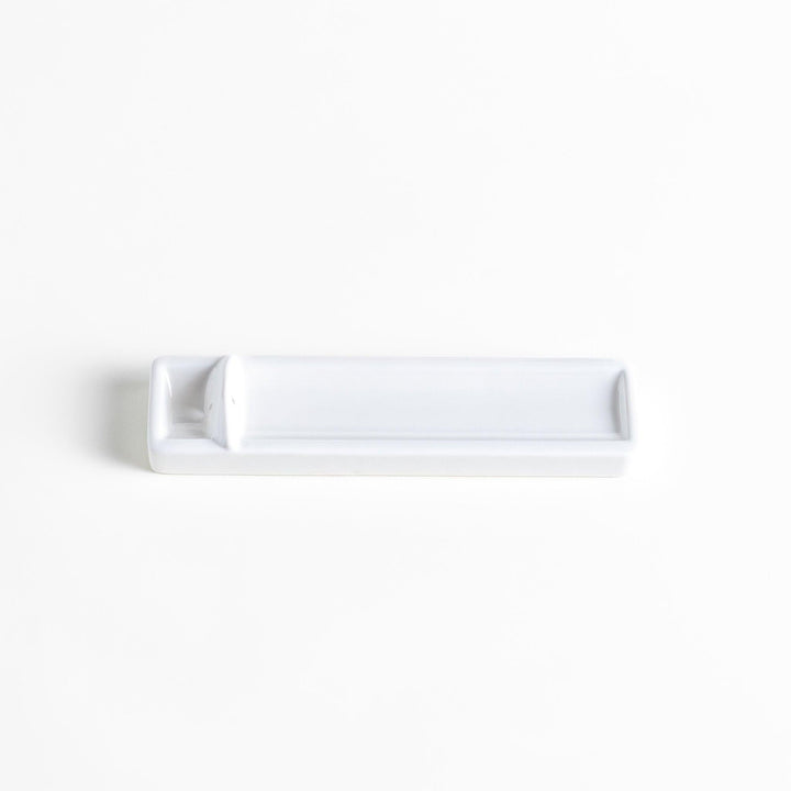 Minimalist white ceramic Japanese incense holder with rectangular shape and slot for clean ash catching.