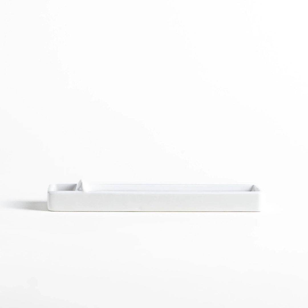 Minimalist white ceramic Japanese incense holder with rectangular shape and slot for clean ash catching.