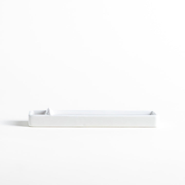 Minimalist white ceramic Japanese incense holder with rectangular shape and slot for clean ash catching.