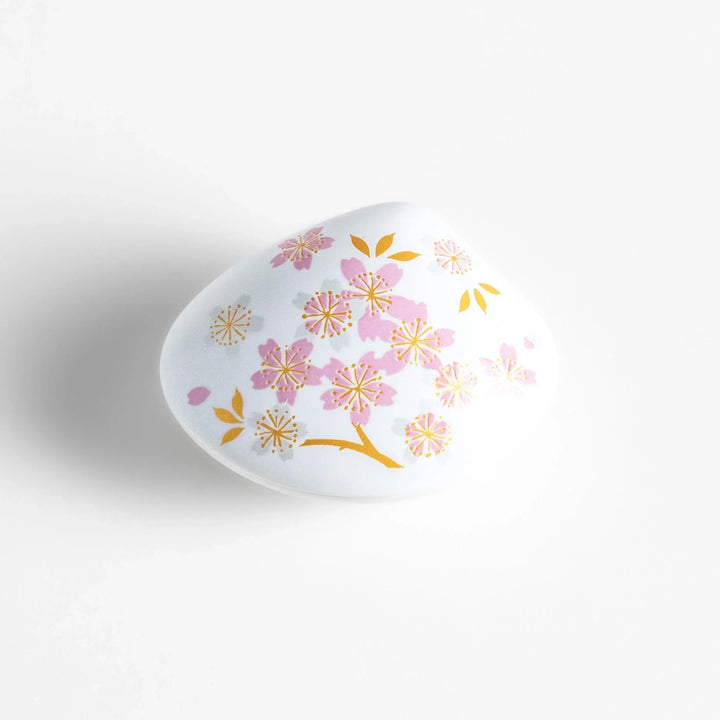 White seashell-shaped incense holder with pink and gold sakura details and blossom stand for a refined touch.