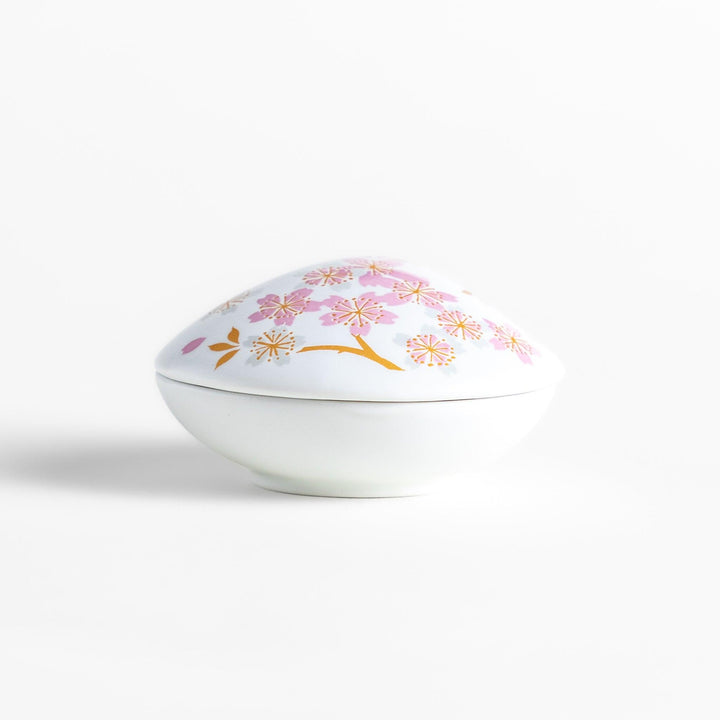 White seashell-shaped incense holder with pink and gold sakura details and blossom stand for a refined touch.