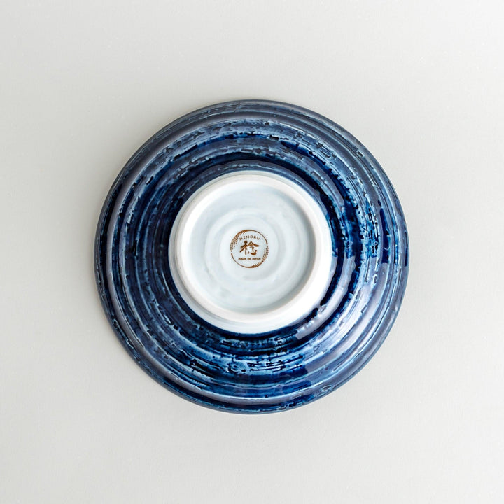A pasta bowl decorated with blue and white whales and waves.
