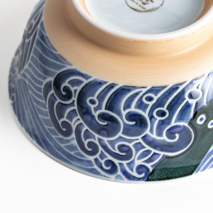 A ramen bowl with a white and blue design, featuring a whale illustration and wave patterns.