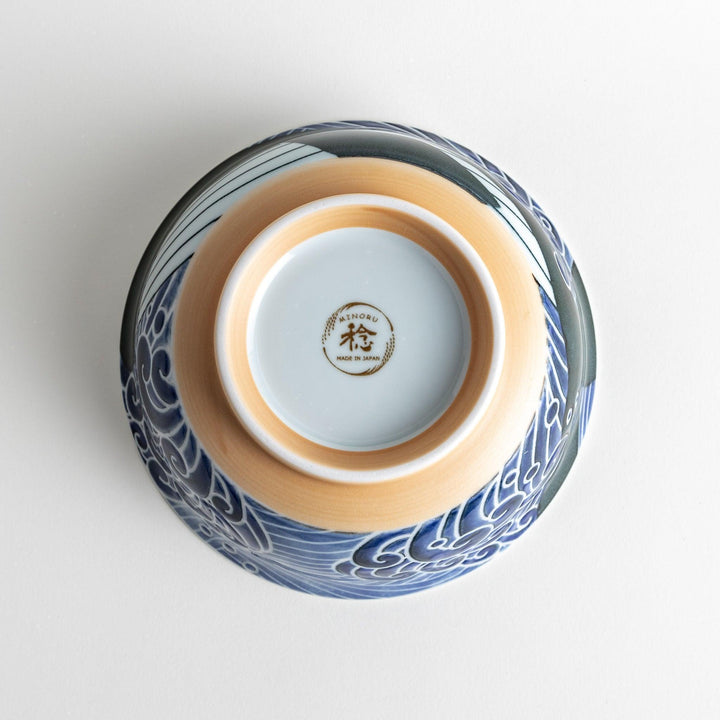 A ramen bowl with a white and blue design, featuring a whale illustration and wave patterns.