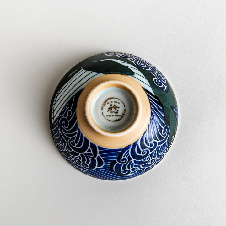 A large rice bowl with a whale and wave design in blue on a white background.