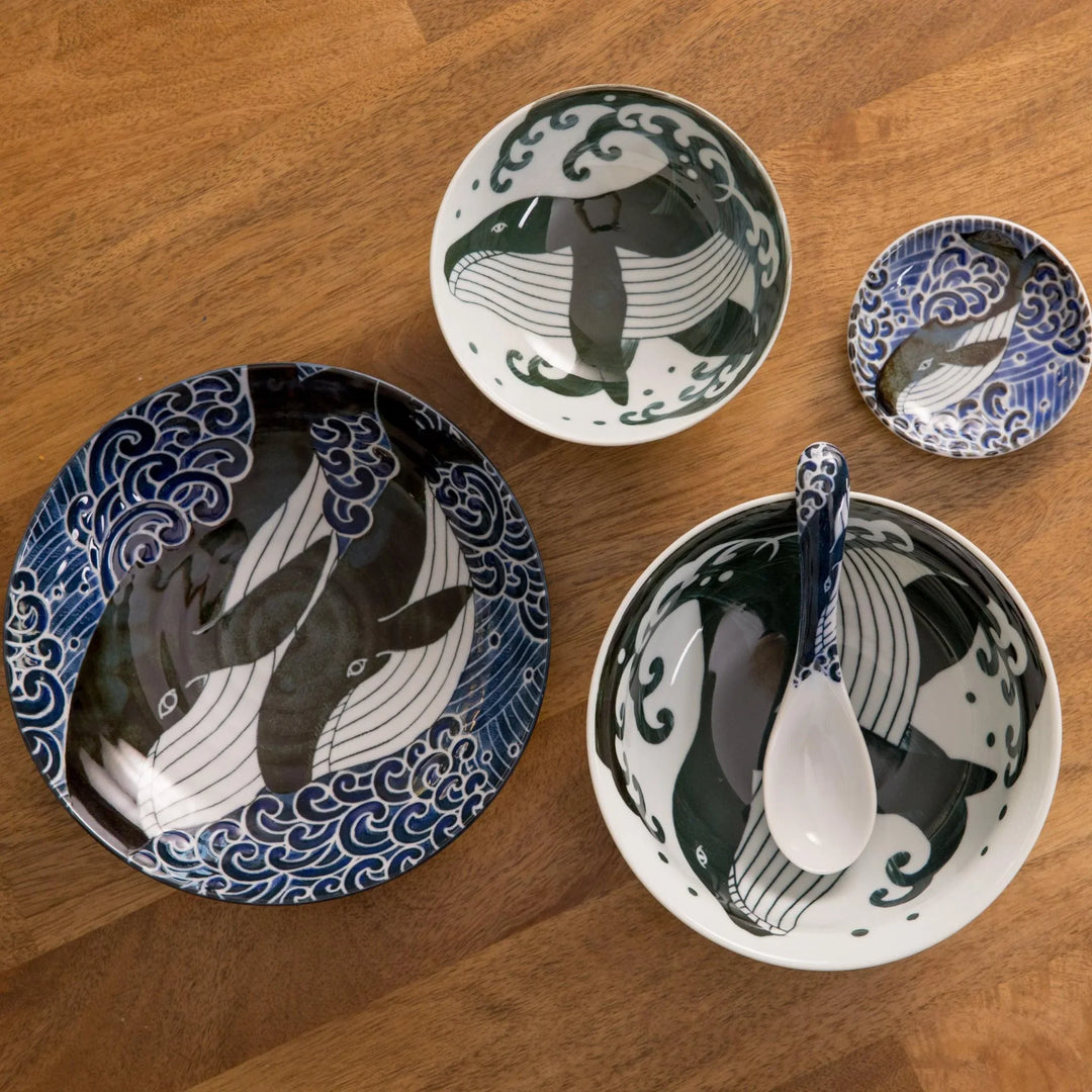 Whale themed Japanese ceramic set with large plate bowls and dish featuring detailed whale and wave motifs.