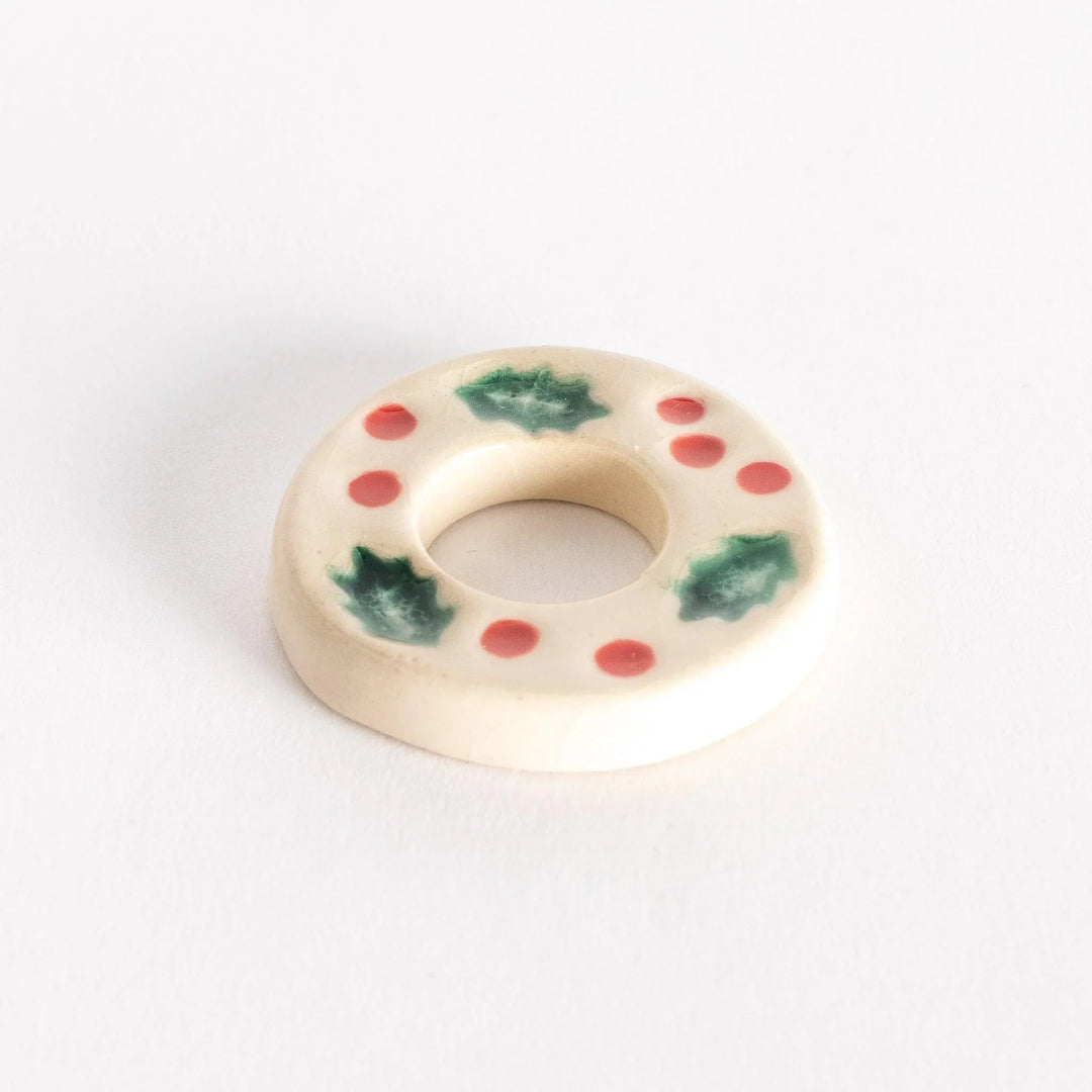 White wreath shaped ceramic chopstick rest with leaf details adding elegant seasonal dining accent.