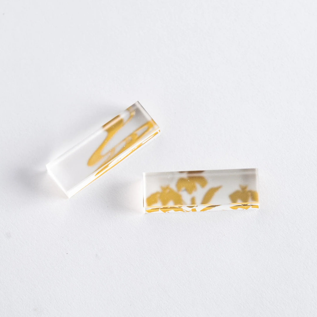 Chopsticks with wisteria and bamboo designs in a gift box, accompanied by clear chopstick rests.