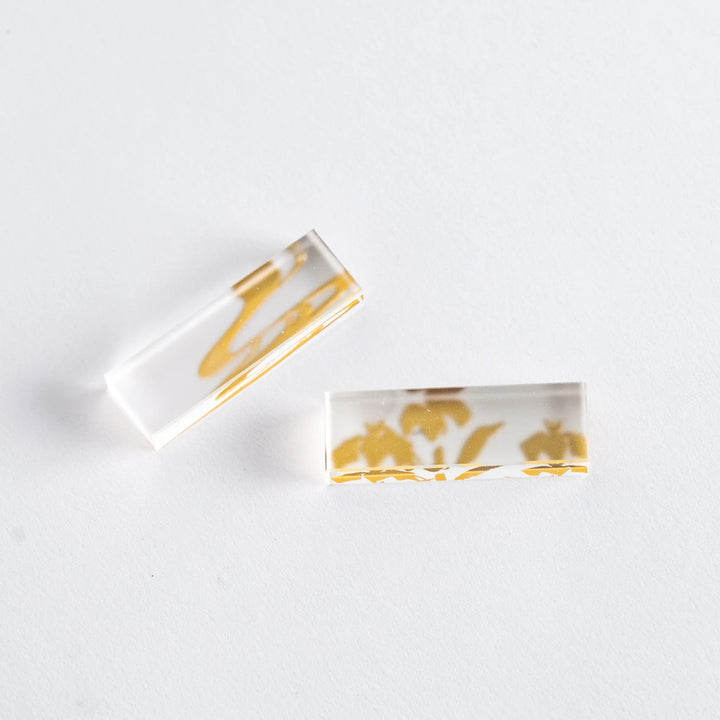 Chopsticks with wisteria and bamboo designs in a gift box, accompanied by clear chopstick rests.