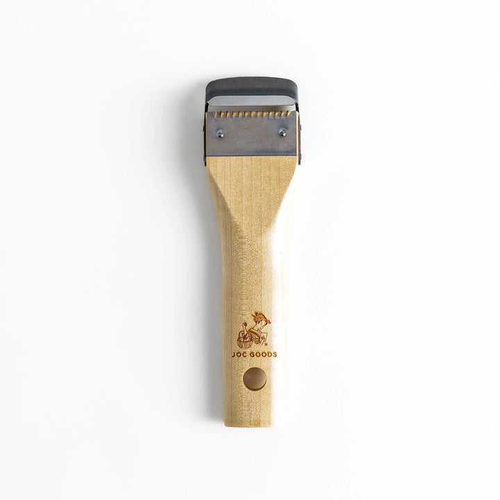 Wood handle julienne peeler with sharp stainless steel blade and JOC Goods logo for vegetable strips.