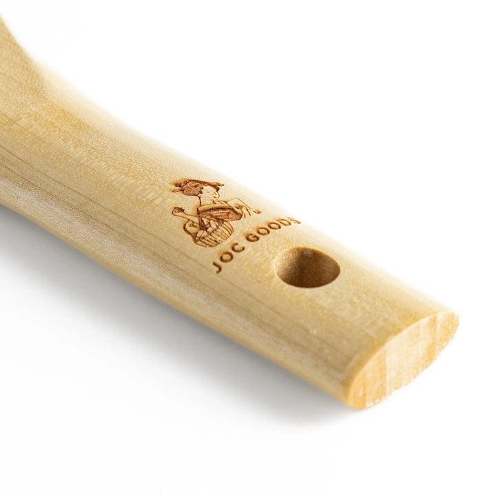 Wood handle julienne peeler with sharp stainless steel blade and JOC Goods logo for vegetable strips.