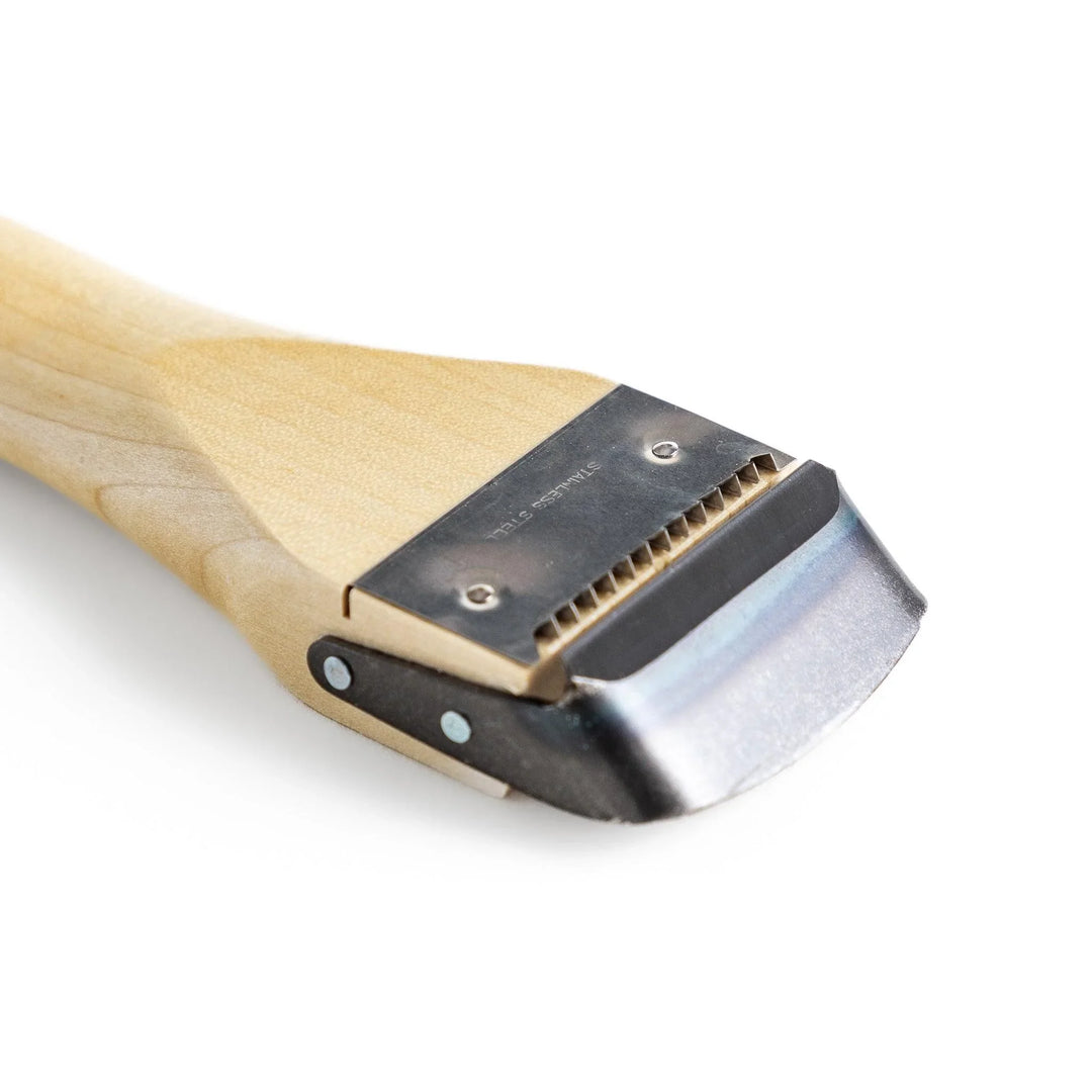 Wood handle julienne peeler with sharp stainless steel blade and JOC Goods logo for vegetable strips.