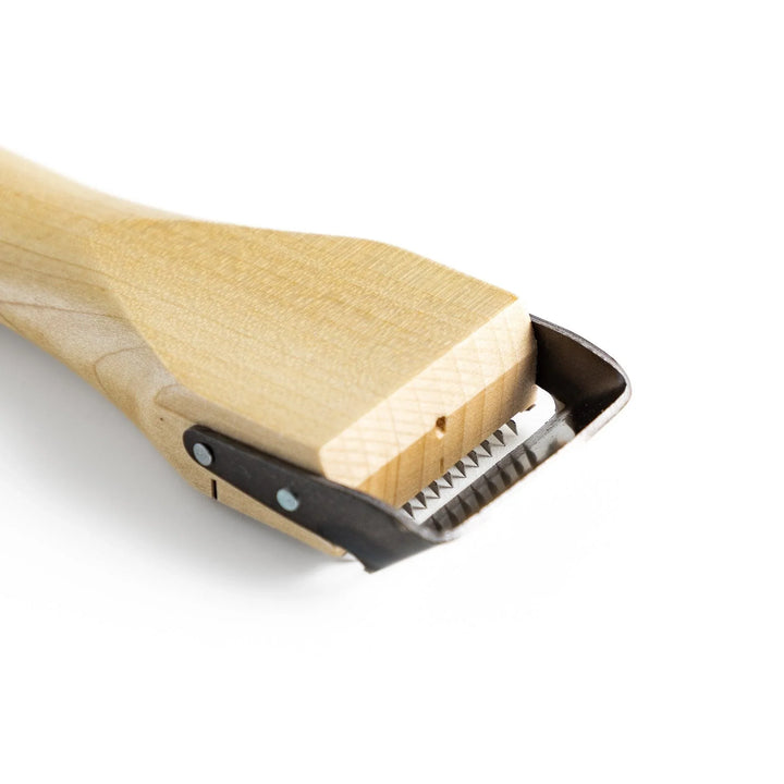 Wood handle julienne peeler with sharp stainless steel blade and JOC Goods logo for vegetable strips.