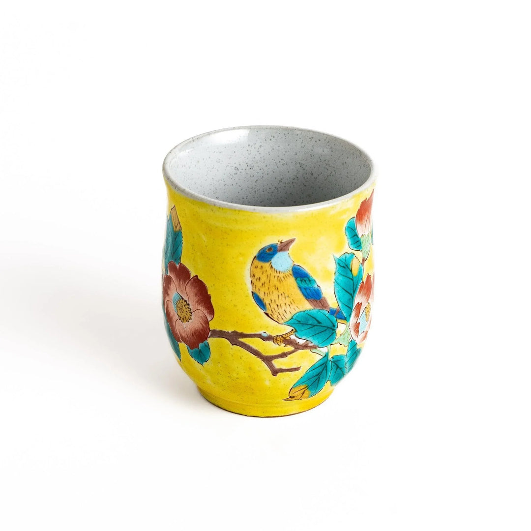Yellow teacup with a colorful bird perched on a flowering branch, perfect for adding a touch of nature to your tea time.