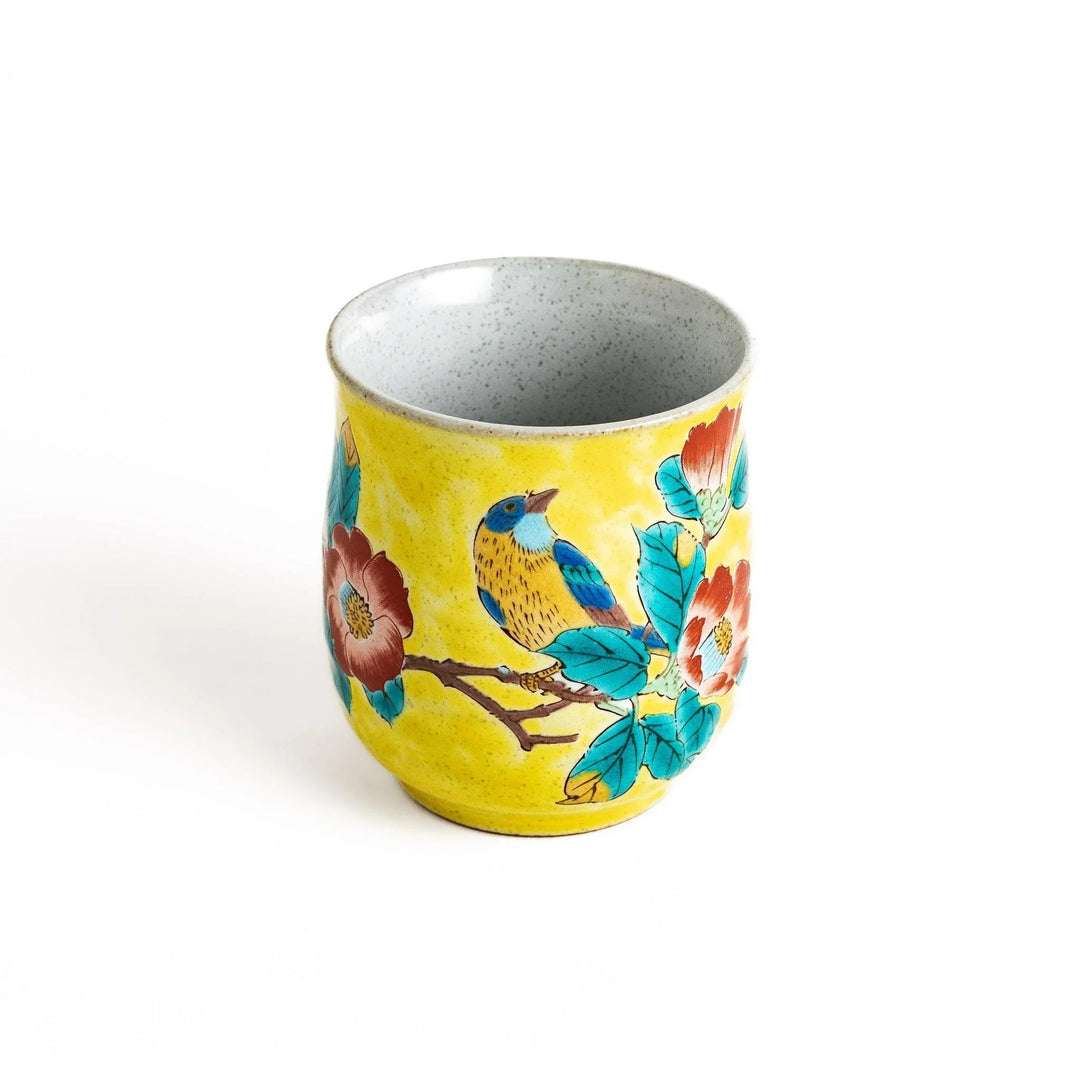 Yellow teacup with a colorful bird perched on a flowering branch, perfect for adding a touch of nature to your tea time.