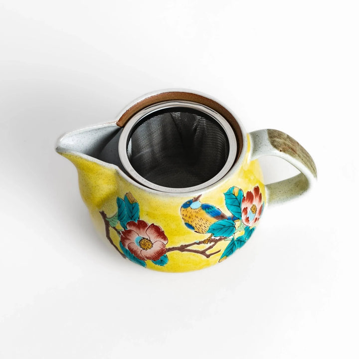 Charming yellow teapot featuring a vibrant bird and camellia design, perfect for adding a touch of elegance to your tea time.
