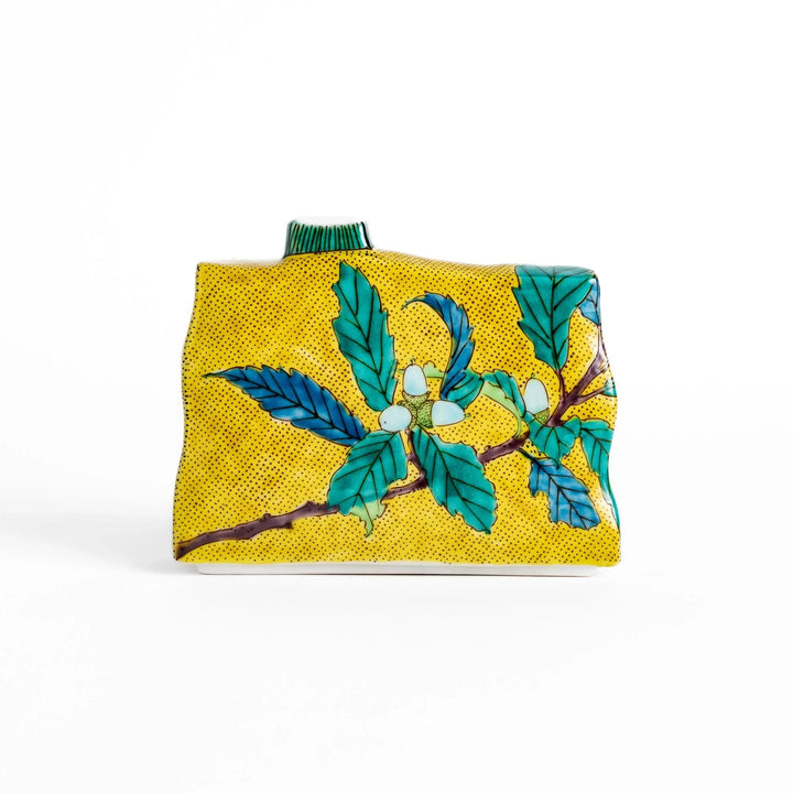 Yellow flower vase with vibrant fruit and leaf designs adding color and elegance to any space.