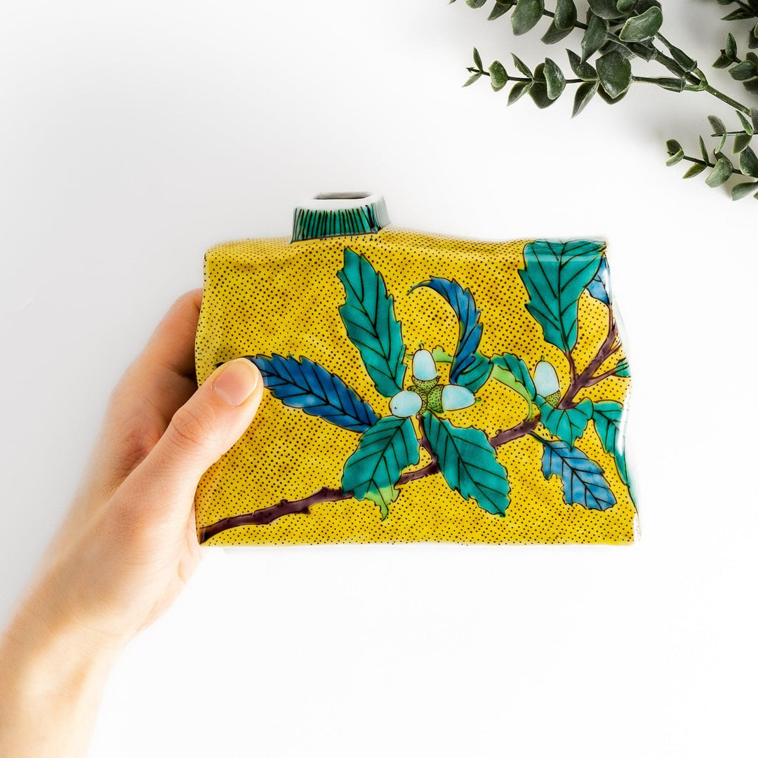 Yellow flower vase with vibrant fruit and leaf designs adding color and elegance to any space.