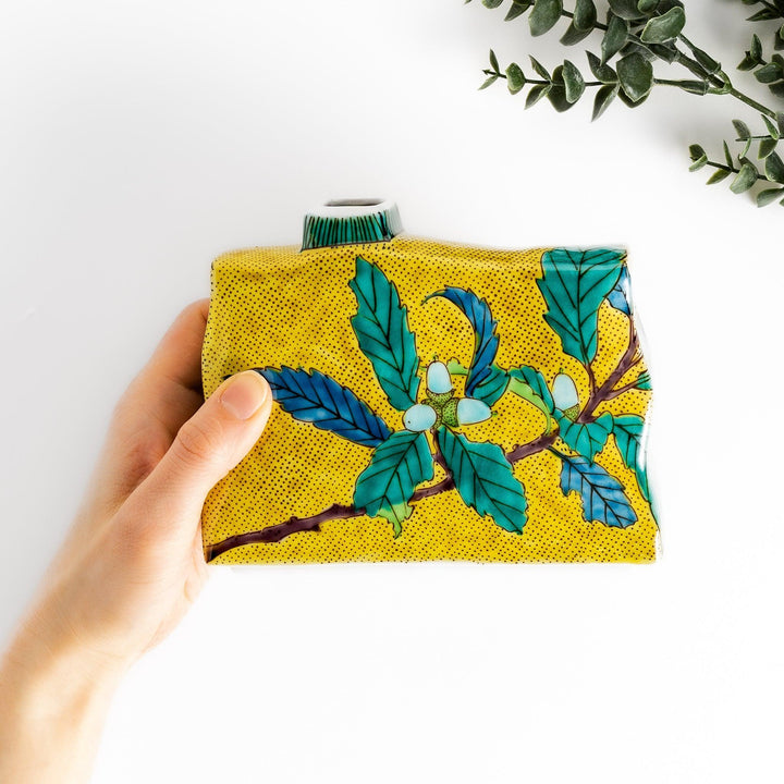 Yellow flower vase with vibrant fruit and leaf designs adding color and elegance to any space.