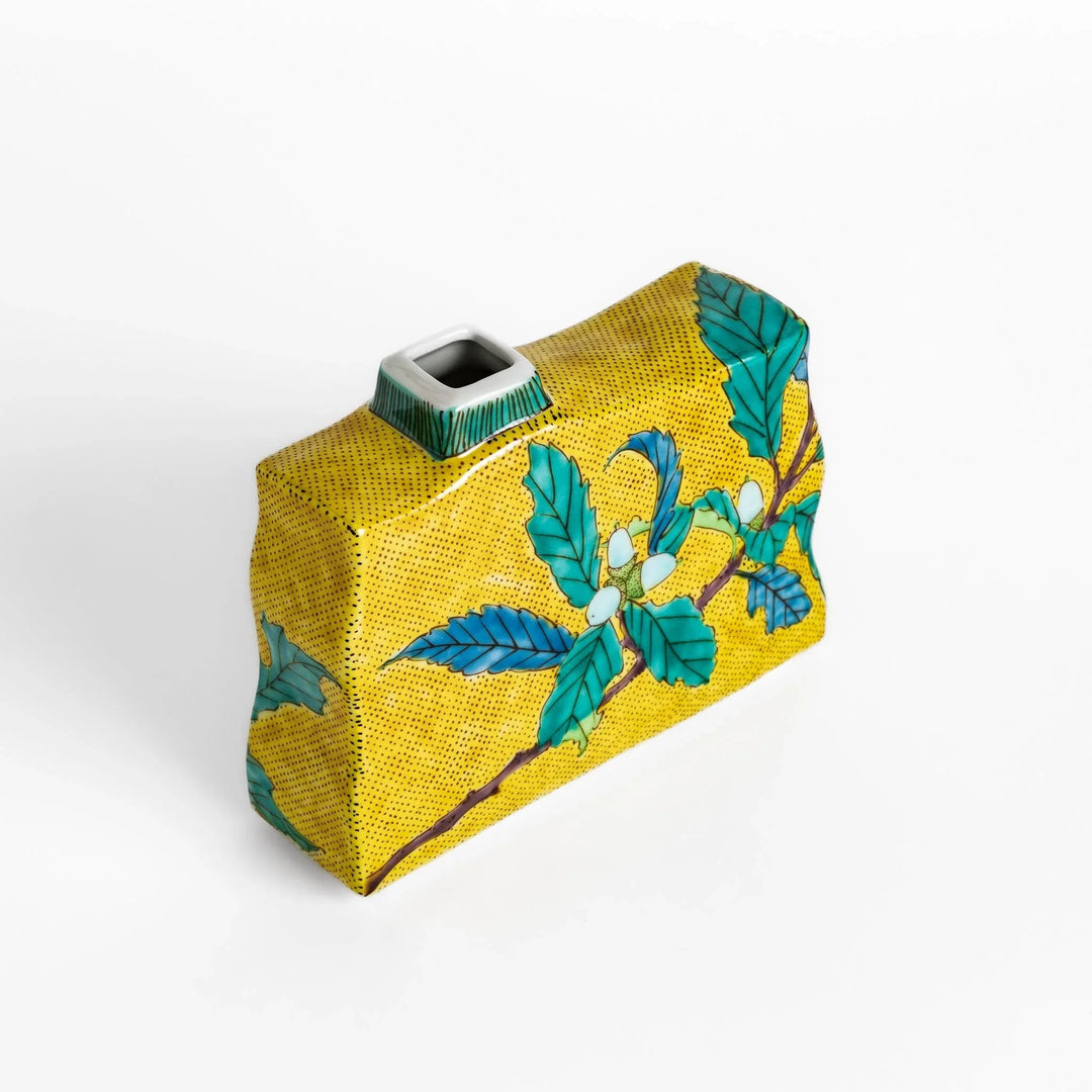 Yellow flower vase with vibrant fruit and leaf designs adding color and elegance to any space.