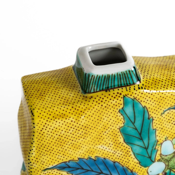 Yellow flower vase with vibrant fruit and leaf designs adding color and elegance to any space.