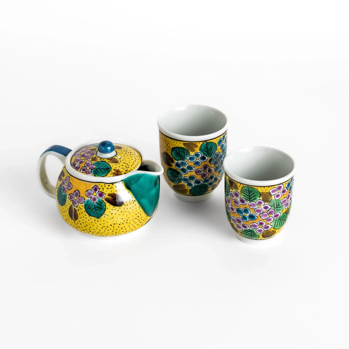 Yellow ceramic teapot with hydrangea pattern and green spout perfect for cheerful daily tea time.