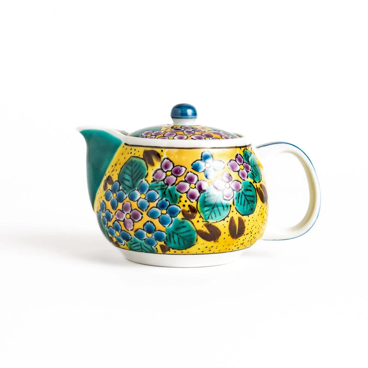Vibrant yellow ceramic teapot with colorful hydrangea design and green spout for cheerful tea time.