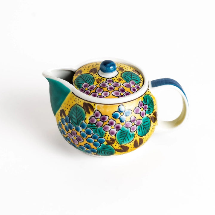 Vibrant yellow ceramic teapot with a colorful hydrangea pattern and a contrasting green spout. Perfect for adding a touch of cheer to your tea time.