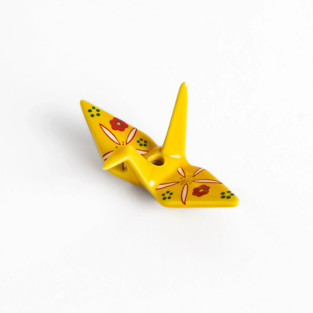 Yellow origami crane incense holder with floral motifs perfect for bringing charm and serenity to any space.
