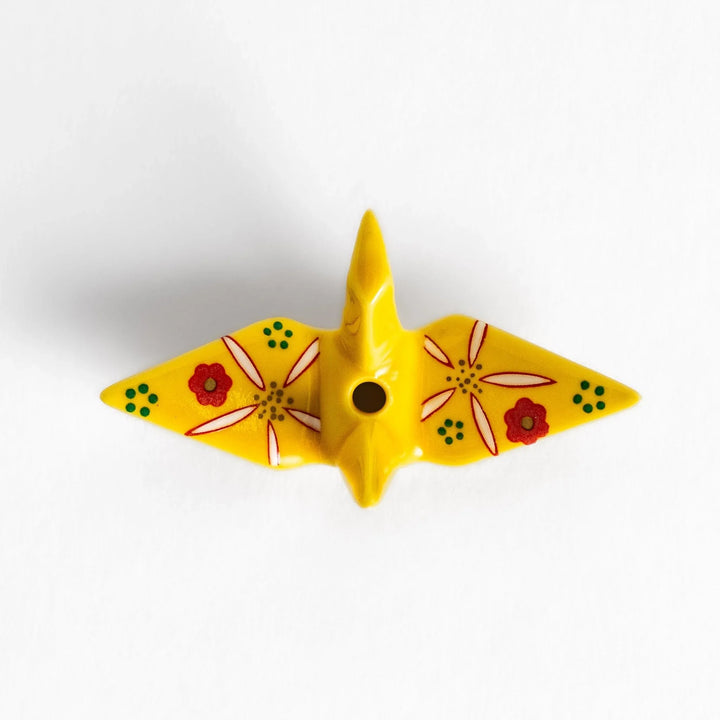 Yellow origami crane incense holder with floral motifs perfect for bringing charm and serenity to any space.