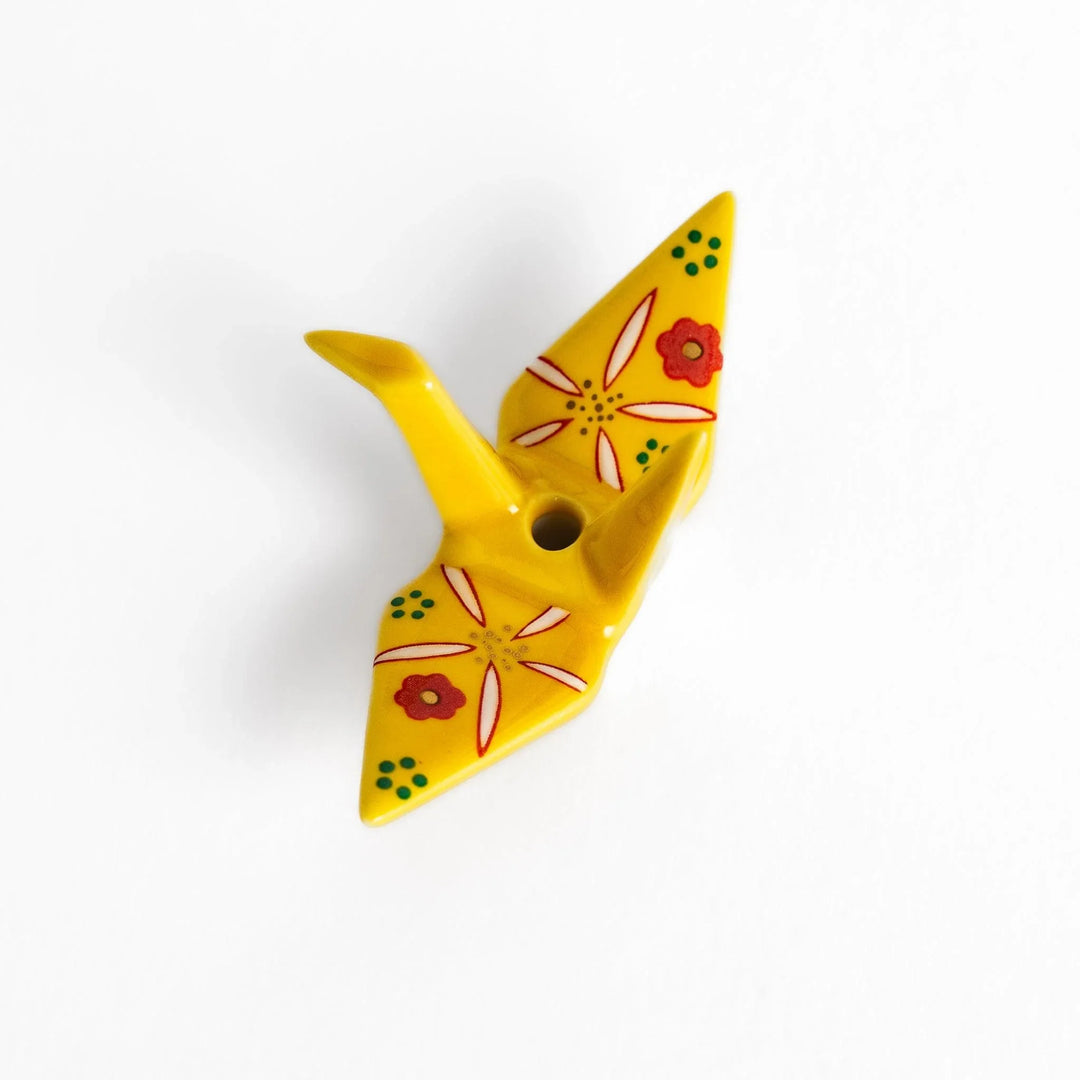 Yellow origami crane incense holder with floral motifs perfect for bringing charm and serenity to any space.
