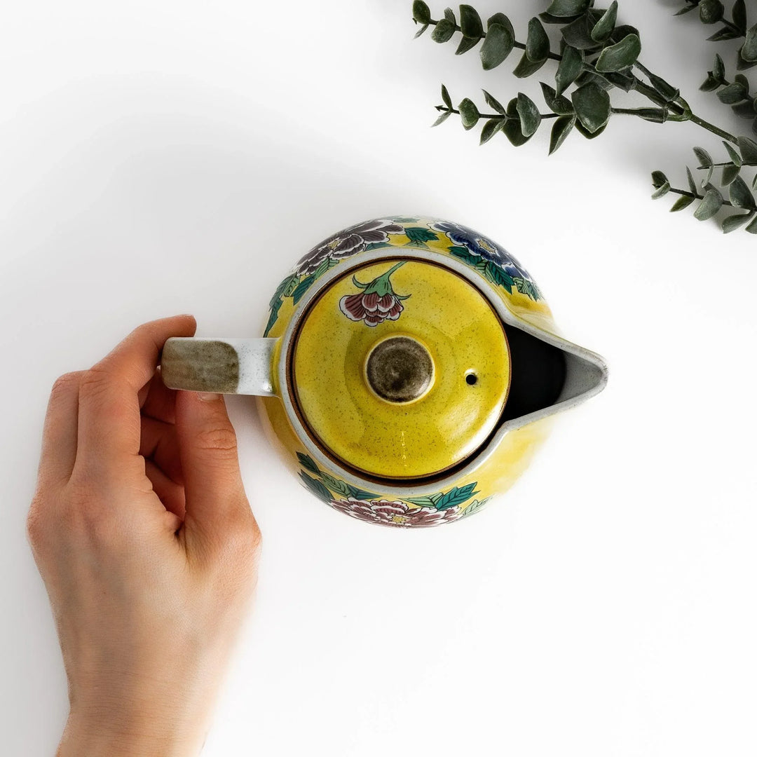 Vibrant yellow teapot adorned with colorful peony flowers, perfect for adding a touch of elegance and charm to your tea time.
