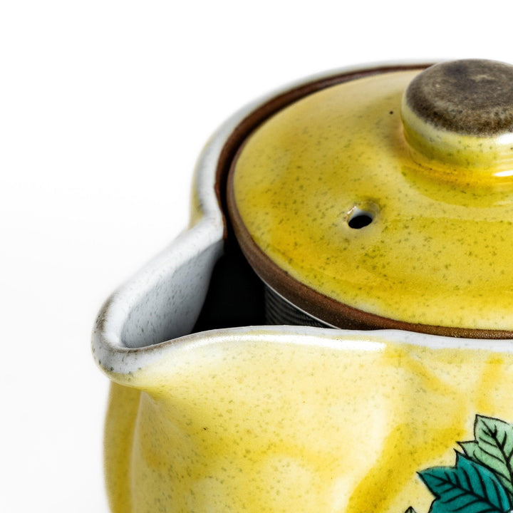 Vibrant yellow teapot adorned with colorful peony flowers, perfect for adding a touch of elegance and charm to your tea time.