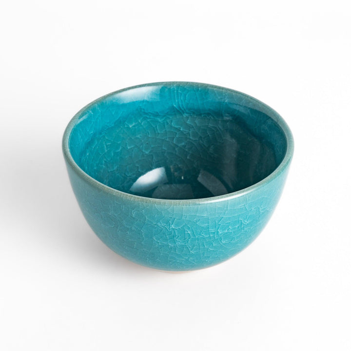 Stunning turquoise Matcha bowl with a unique crackle glaze, perfect for enjoying a traditional Japanese tea ceremony.