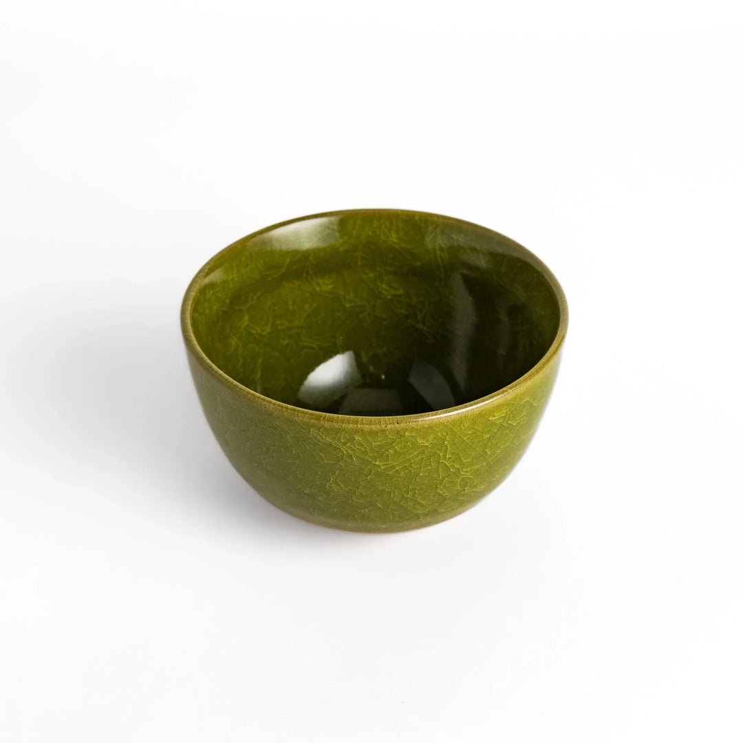 Artistic ceramic Matcha Bowl featuring a rich green glaze and a contrasting base.