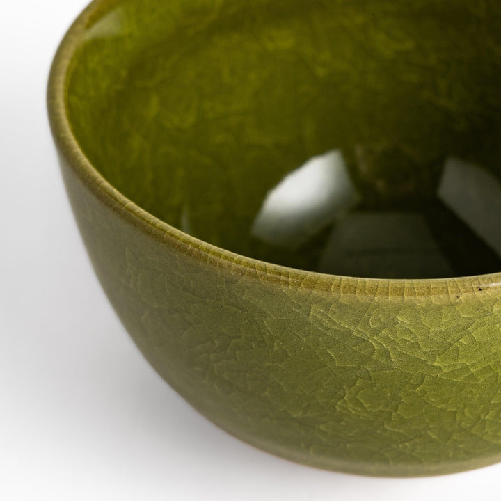Artistic ceramic Matcha Bowl featuring a rich green glaze and a contrasting base.