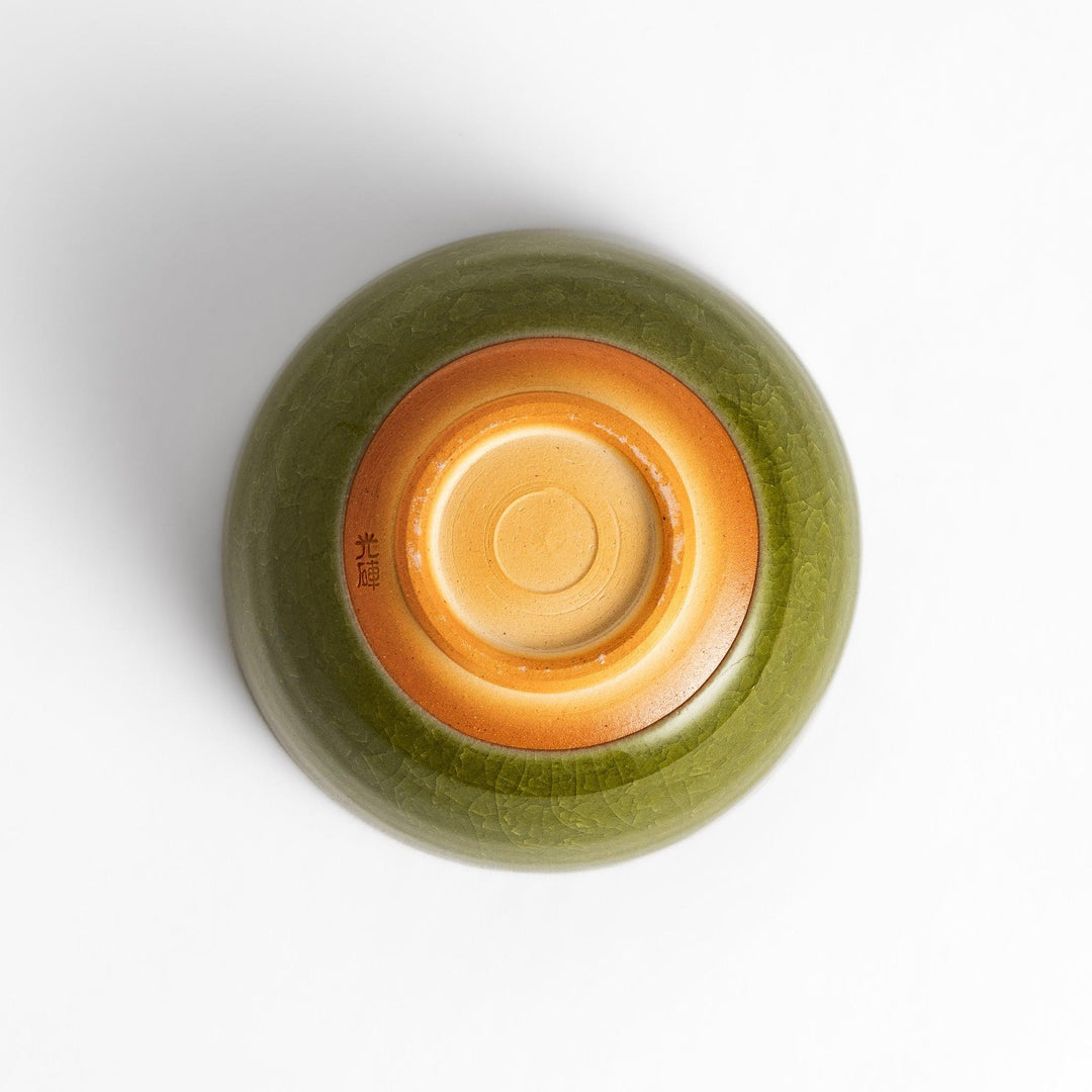 Artistic ceramic Matcha Bowl featuring a rich green glaze and a contrasting base.