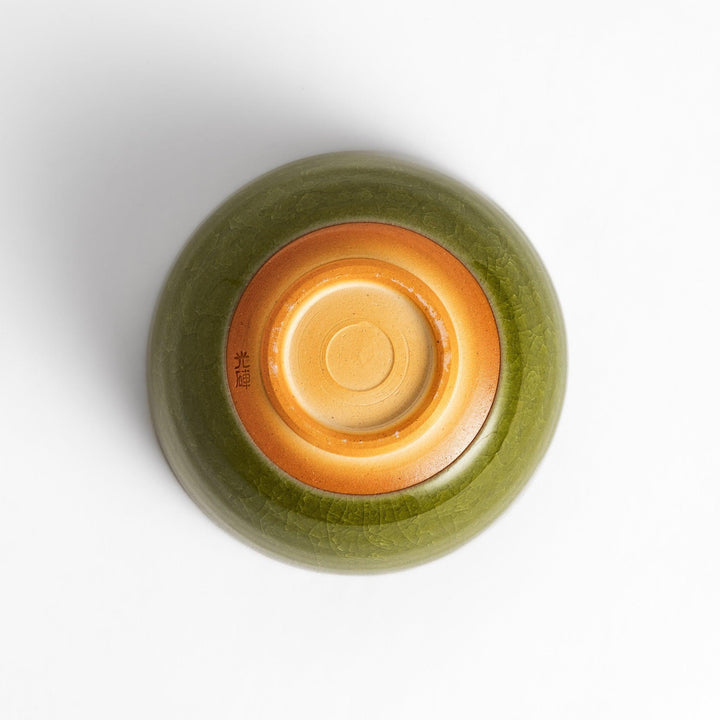Artistic ceramic Matcha Bowl featuring a rich green glaze and a contrasting base.
