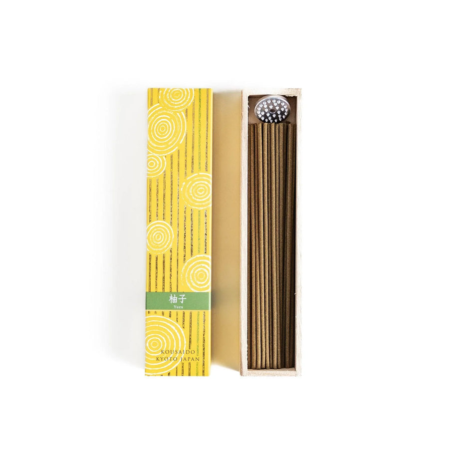 Japanese Yuzu incense sticks presented in a yellow box with circular patterns and a wooden holder, crafted by Kousaido Kyoto