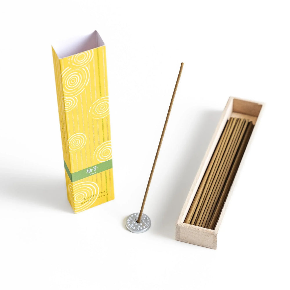 Japanese Yuzu incense sticks presented in a yellow box with circular patterns and a wooden holder, crafted by Kousaido Kyoto
