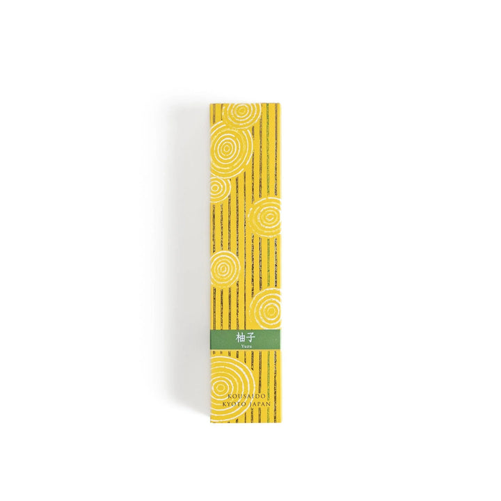 Japanese Yuzu incense sticks presented in a yellow box with circular patterns and a wooden holder, crafted by Kousaido Kyoto