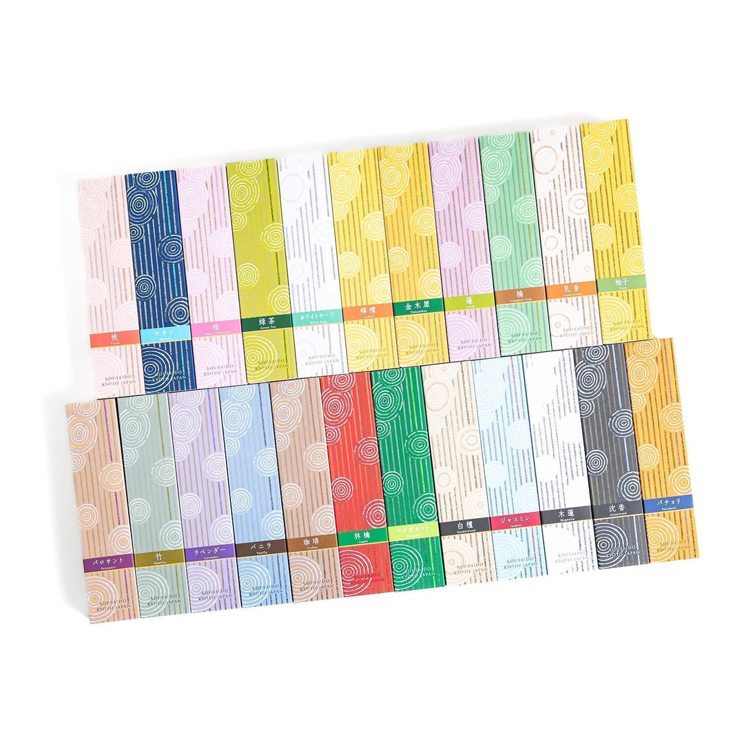 Incense collection with various fragrances in elegant boxes featuring white circular patterns on bold colors.